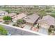 Aerial view of a residential neighborhood showcasing houses with tile roofs and desert landscaping at 43154 N Outer Banks Dr, Anthem, AZ 85086