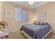 Spacious bedroom with a large bed and window coverings at 43154 N Outer Banks Dr, Anthem, AZ 85086