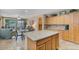 Open kitchen features granite island, stainless steel appliances, and oak cabinets at 43154 N Outer Banks Dr, Anthem, AZ 85086