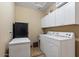 Laundry room with washer, dryer, and upper cabinets at 43154 N Outer Banks Dr, Anthem, AZ 85086