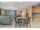 Kitchen and dining area with glass table and chairs, open to living room at 43154 N Outer Banks Dr, Anthem, AZ 85086