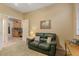 Cozy sitting room with a leather couch and access to the kitchen at 43154 N Outer Banks Dr, Anthem, AZ 85086