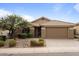 One-story house with a brown garage door and desert landscaping at 43154 N Outer Banks Dr, Anthem, AZ 85086