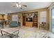 Living room with tiled floors, ceiling fan, and built-in shelving at 43154 N Outer Banks Dr, Anthem, AZ 85086