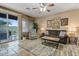 Living room with tiled floors, sliding door to patio, and comfortable seating at 43154 N Outer Banks Dr, Anthem, AZ 85086