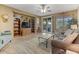 Living room with tiled floors, wood shelving, and comfortable seating at 43154 N Outer Banks Dr, Anthem, AZ 85086