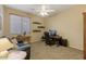 Bright home office features a desk, comfortable seating, and built-in shelves at 43154 N Outer Banks Dr, Anthem, AZ 85086
