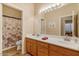 Clean bathroom with double sinks and wood cabinets at 43154 N Outer Banks Dr, Anthem, AZ 85086