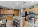 Island kitchen with granite countertops, stainless steel appliances, and oak cabinets at 43154 N Outer Banks Dr, Anthem, AZ 85086