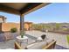 Covered patio with seating area and mountain views at 13190 W Horsetail Trl, Peoria, AZ 85383
