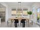 Bright dining room with wood table and modern light fixture at 13190 W Horsetail Trl, Peoria, AZ 85383