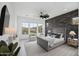 Spacious main bedroom with a stone accent wall and large windows at 13190 W Horsetail Trl, Peoria, AZ 85383