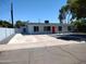 Newly renovated single story home with red door and gray rock landscaping at 1437 E Wesleyan Dr, Tempe, AZ 85282