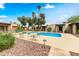 Community pool with patio furniture and lush landscaping at 16819 E Gunsight Dr # A12, Fountain Hills, AZ 85268