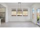 Bright dining area with large windows and modern chandelier at 13190 W Horsetail Trl, Peoria, AZ 85383