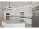 Modern kitchen with white cabinets, granite countertops, and stainless steel appliances at 13190 W Horsetail Trl, Peoria, AZ 85383