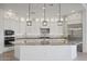 Modern kitchen with white cabinets, granite countertops, and stainless steel appliances at 13190 W Horsetail Trl, Peoria, AZ 85383