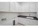 Laundry room with white cabinets and gray countertop at 13190 W Horsetail Trl, Peoria, AZ 85383