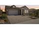 Craftsman style home with a two-car garage and landscaped front yard at 13190 W Horsetail Trl, Peoria, AZ 85383