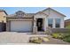 Modern home exterior with gray siding and a white front door at 13190 W Horsetail Trl, Peoria, AZ 85383