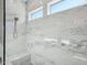 Spa-like shower with marble tile and built-in bench seat at 13190 W Horsetail Trl, Peoria, AZ 85383
