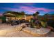 Relaxing patio with a spa, fireplace, and seating area at 7755 E Evening Glow Dr, Scottsdale, AZ 85266