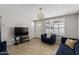 Living room featuring a flat-screen TV and comfortable seating at 6212 W Cambridge Ave, Phoenix, AZ 85035