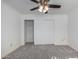 Bright bedroom with ceiling fan, carpet, and double door closet at 1360 E Brown Rd # 25, Mesa, AZ 85203