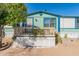 Charming single-story home with light green exterior, deck, and landscaping at 3551 W Ross Ave, Glendale, AZ 85308