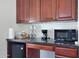 Compact kitchenette with microwave, coffee maker, and mini-fridge at 8876 S Santa Elizabeth Dr, Goodyear, AZ 85338
