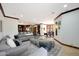 Open living room with sectional sofa, views into kitchen and dining areas at 8876 S Santa Elizabeth Dr, Goodyear, AZ 85338