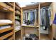 Well-organized walk-in closet with shelves, drawers, and hanging rods at 8876 S Santa Elizabeth Dr, Goodyear, AZ 85338
