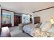 Main bedroom with large bed, sitting area, and built-ins at 8876 S Santa Elizabeth Dr, Goodyear, AZ 85338