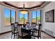 Bright dining room features a large table, scenic views, and elegant light fixture at 8876 S Santa Elizabeth Dr, Goodyear, AZ 85338