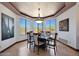 Sunlit dining room boasts a table for six and picturesque views at 8876 S Santa Elizabeth Dr, Goodyear, AZ 85338