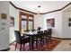 Formal dining room with dark wood table and red patterned rug at 8876 S Santa Elizabeth Dr, Goodyear, AZ 85338