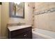 Bathroom boasts granite vanity, mosaic tile, and a bathtub at 8876 S Santa Elizabeth Dr, Goodyear, AZ 85338
