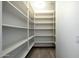 Spacious pantry with ample shelving for food storage at 8876 S Santa Elizabeth Dr, Goodyear, AZ 85338