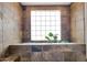 Bathroom with a large window and stone tile at 8876 S Santa Elizabeth Dr, Goodyear, AZ 85338