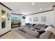 Relaxing living room with a large sectional sofa and a large TV at 8876 S Santa Elizabeth Dr, Goodyear, AZ 85338