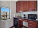 Kitchenette features a window, microwave, coffee maker, and mini-fridge at 8876 S Santa Elizabeth Dr, Goodyear, AZ 85338