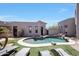 Freeform pool with waterfall feature and plenty of lounge space at 8876 S Santa Elizabeth Dr, Goodyear, AZ 85338