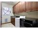 Bright laundry room with modern washer, dryer, and wood cabinets at 8876 S Santa Elizabeth Dr, Goodyear, AZ 85338