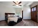 Comfortable bedroom with king-size bed and ceiling fan at 8876 S Santa Elizabeth Dr, Goodyear, AZ 85338