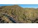 Aerial view showing desert landscape with cacti and a paved road at 41521 N 75Th Pl, Cave Creek, AZ 85331