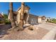 Tan house with a single-car garage and desert landscaping at 3122 E Windmere Dr, Phoenix, AZ 85048