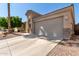 Tan house with a single-car garage and a tree at 3122 E Windmere Dr, Phoenix, AZ 85048