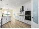 Modern kitchen with white cabinets, stainless steel appliances and a large island at 27536 N Freedom St, San Tan Valley, AZ 85144