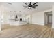 Open concept kitchen and living area with modern island and vinyl plank flooring at 27536 N Freedom St, San Tan Valley, AZ 85144