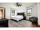 Comfortable bedroom with a queen-size bed, hardwood floors, and access to a private patio at 24546 N 91St St, Scottsdale, AZ 85255